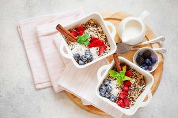 Healhty vegan breakfast bowl. Quinoa with cinnamon and fresh berries overhead