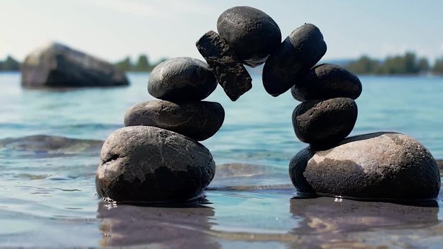 Rocks balancing in an arc in the water