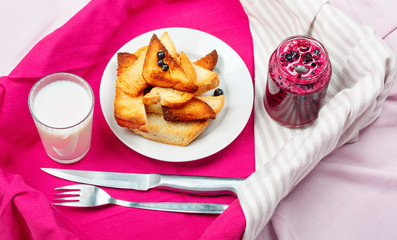 Delicious toasts bread with homemade currant jam with milk