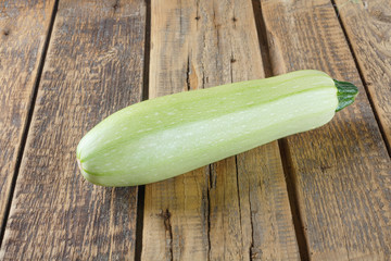 Fresh ripe delicious zucchini on  wooden table