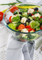 Salad of fresh vegetables and cheese on  served table