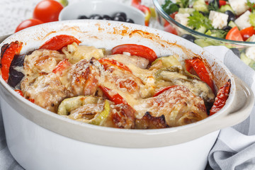 Traditional tasty rustic stew of chicken and vegetables  with Greek salad and black olives