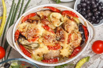 Traditional tasty rustic stew of chicken and vegetables  with Greek salad and black olives