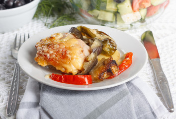 Traditional rustic stew of chicken and vegetables on plate with tomatoes, peppers