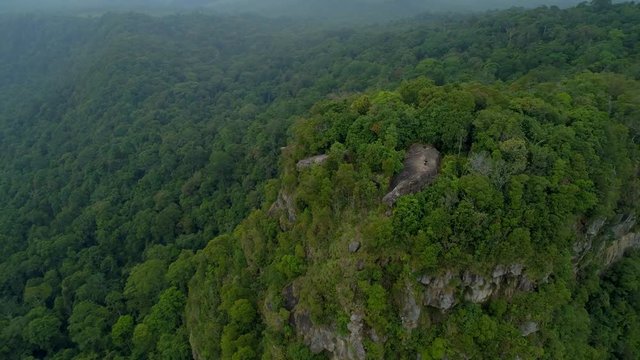 Standing on top of Tab kak hang nak hill mountain cliff at krabi thailand - aerial drone shot
