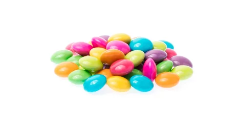 Fototapeten Close up of a pile of colorful chocolate coated candy isolated on white background © cloud7days