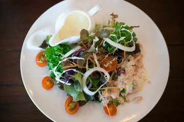 Tuna salad in white dish on dark wood table | Food photograph