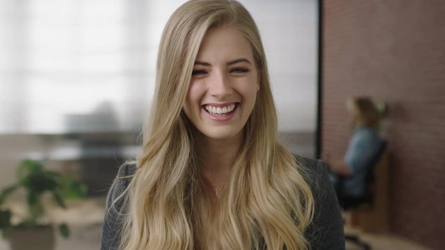 portrait of attractive young blonde woman executive smiling cheerful enjoying start up business opportunity