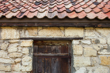 Fototapeta na wymiar Brick wall with tiled roof