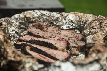 Roast beef in foil in a barbecue