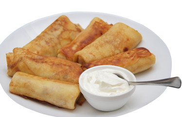 fresh crapes with sour cream on whte plate 