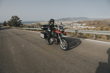 Fototapeta na wymiar Man riding a touring motorbike during a trip across the mountains.