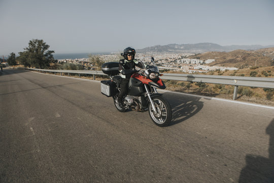 Man riding a touring motorbike during a trip across the mountains.