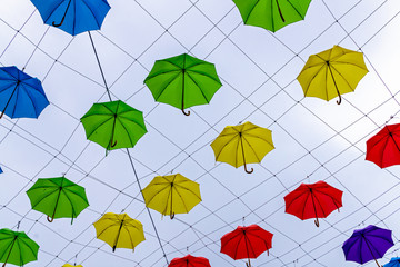 Fototapeta na wymiar Colorful umbrellas in the sky. Street decoration in Devon, Exeter, UK