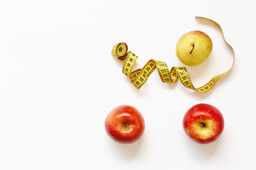 Measure tape and fresh fruits apples, pear on white background. Loss weight, slim body, healthy diet concept