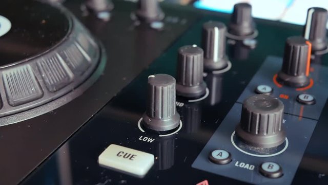 DJ adjusting the audio filter on the mixing controller
