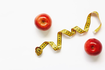 Measure tape and fresh fruits apples on white background. Loss weight, slim body, healthy diet concept