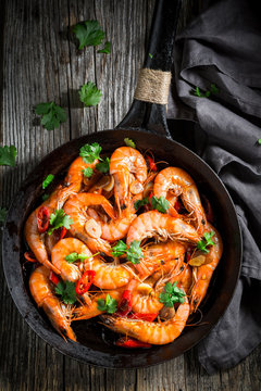Top view of shrimps on pan with garlic and peppers