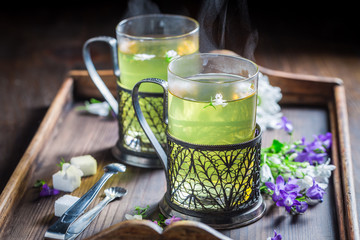 Aromatic hot green tea on old wooden table