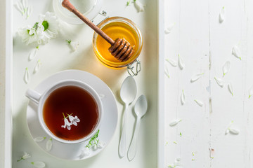 Hot tea with honey on white background
