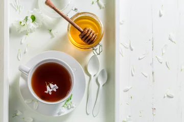 Papier Peint photo Theé Hot tea with honey on white background