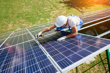 Innovative solar panels installing by professional mounter. High-tech exterior, modern equipment, ecological friendly, green energy. Innovative electricity saving, using renewable energy of sun.