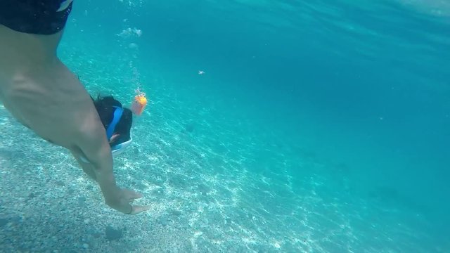 Young man diving with mask on paradisiac beach