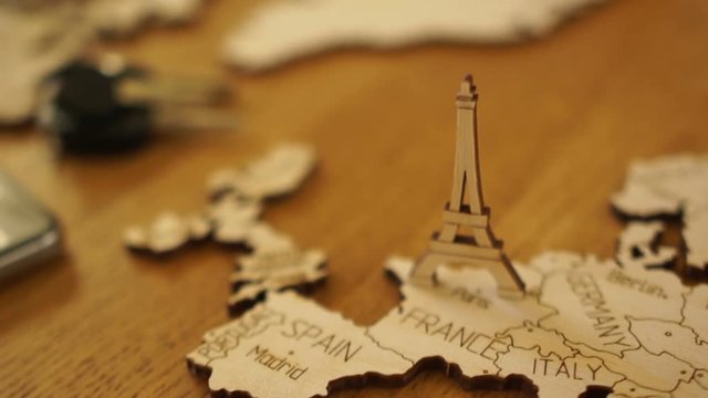 The camera gradually focuses on the wooden model of the map of Europe. Model of wood Eiffel Tower. Attractions in Paris, France