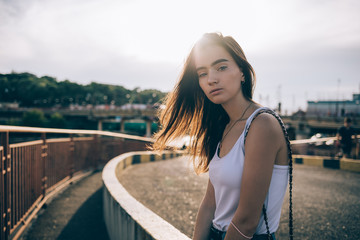 Beautiful young woman wearing white top and jeans