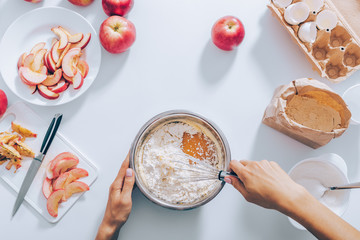 Top view woman mixing flour and eggs to prepare dough