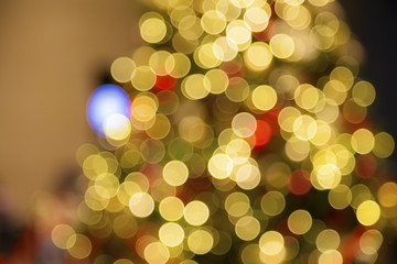 Blurry red Christmas balls on artificial Christmas tree.Christmas Holiday Blurred Background.