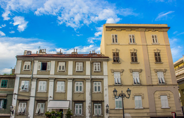 beautiful cozy and calm Italian yard building apartment facade in old city backstreet district in colorful bright summer day time with blue sky cloud background