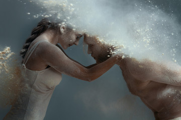 Dancing in flour concept. Girl woman female and muscle fitness guy man male couple in love and in...
