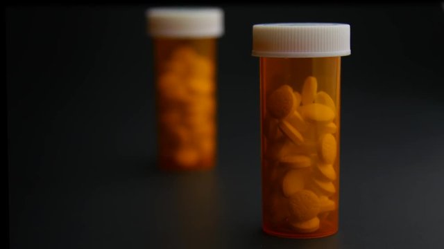 Pill Bottle Full of Opioids on Table Rack Focus