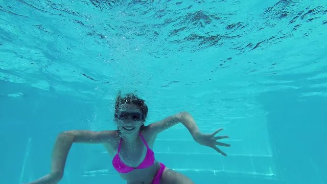 Little girl in pool underwater