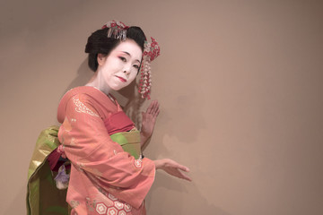 Clipping japanese geisha maiko girl in red kimono coifed hair brooch with patterns of red and white...