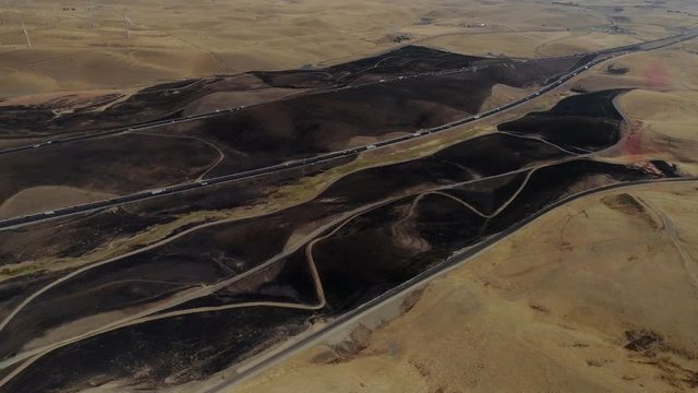Aerial footage of a 650 acre fire started in the Altamont hills between Tracy and Livermore in California.