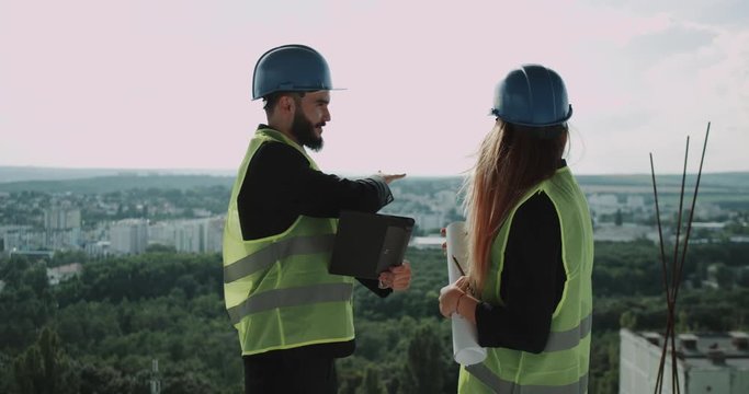 Two young businessman and expert engineer discusse about the next construction site , make a great deal at the end holding hands. 4k