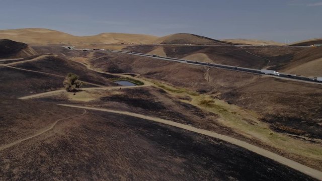 Aerial footage of a 650 acre fire started in the Altamont hills between Tracy and Livermore in California.