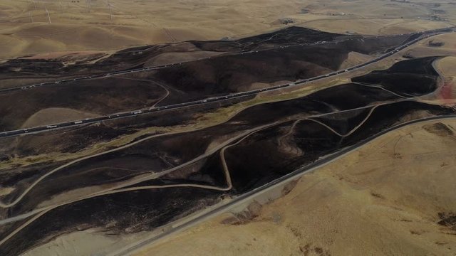 Aerial footage of a 650 acre fire started in the Altamont hills between Tracy and Livermore in California.