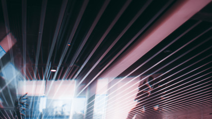 Office ceiling with striped pattern of plenty of parallel long soundproof panels and strong...