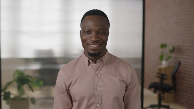 portrait of young african american businessman smiling enjoying successful start up business confident entrepreneur in modern office workspace 