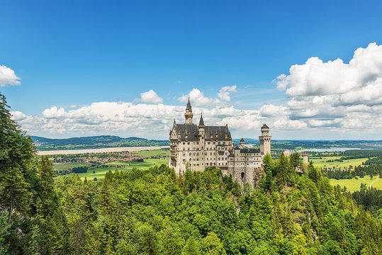 Hohenschwangau, Germany - June 10, 2018: The idyllic Neuschwanstein Castle positioned high up on a mountain in the Bavarian Alps. Commissioned by King Ludwig II of Bavaria.