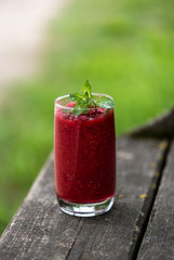 Raspberry smoothies with mint on rustic background