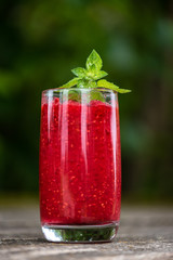 Raspberry smoothies with mint on rustic background