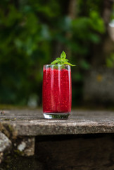 Raspberry smoothies with mint on rustic background