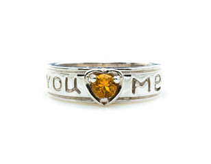 classic ring with a yellow topaz stone on white background