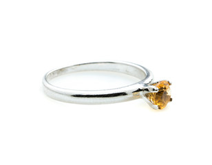 classic ring with a yellow topaz stone on white background