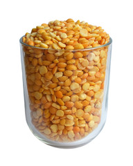 Transparent glass cup filled with dry yellow chipped peas isolated on white background close-up