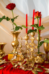 Golden background, roses in a vase, various gilt objects of everyday life